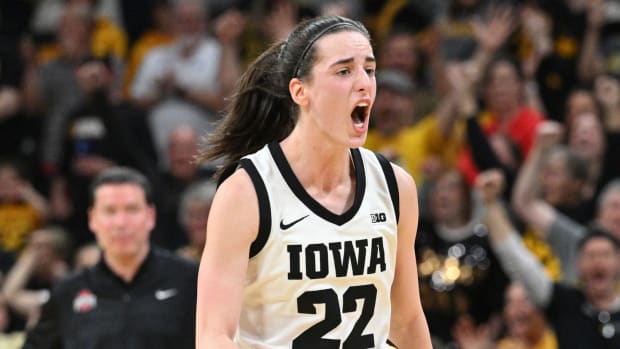 Iowa Hawkeyes guard Caitlin Clark reacts after breaking the NCAA basketball all-time scoring record during the second quarter against the Ohio State Buckeyes.
